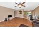 Open-concept living room with a ceiling fan, wood floors and an abundance of natural light at 8140 E Mitchell Dr, Scottsdale, AZ 85251
