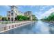 Scenic waterfront view with modern buildings and lush landscaping under a bright sky at 8140 E Mitchell Dr, Scottsdale, AZ 85251