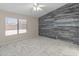 Bedroom featuring stylish plank accent wall, ceiling fan, and marble-look tile flooring at 9231 W Grovers Ave, Peoria, AZ 85382