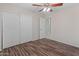 Bedroom with wood look vinyl flooring, ceiling fan, and large closet at 9231 W Grovers Ave, Peoria, AZ 85382