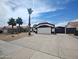 Single-story home featuring tile roof, desert landscaping, driveway, and an attached garage at 9231 W Grovers Ave, Peoria, AZ 85382