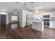 Open concept kitchen with white cabinets, stainless appliances, and a center island at 9231 W Grovers Ave, Peoria, AZ 85382