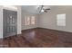Inviting living room with sleek hard surface floors, a ceiling fan and a front door entrance at 9231 W Grovers Ave, Peoria, AZ 85382