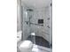 Walk-in shower featuring rainfall shower head, black matte hardware, and marble tiled walls at 9231 W Grovers Ave, Peoria, AZ 85382