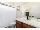 Bathroom with a wood vanity, white countertop, and framed mirror at 9622 S 46Th Ln, Laveen, AZ 85339