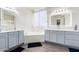 Bright bathroom with double vanity sinks, a soaking tub, and modern finishes at 9622 S 46Th Ln, Laveen, AZ 85339