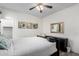 Bedroom featuring wood grain laminate floors, neutral walls, a ceiling fan, and closet with a dresser at 9622 S 46Th Ln, Laveen, AZ 85339