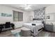 Comfortable bedroom with a ceiling fan, desk, and tufted headboard at 9622 S 46Th Ln, Laveen, AZ 85339