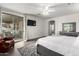 Bright bedroom featuring an area rug, a ceiling fan, and a private patio entrance at 9622 S 46Th Ln, Laveen, AZ 85339