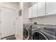 Functional laundry room featuring front-loading washer and dryer at 9622 S 46Th Ln, Laveen, AZ 85339