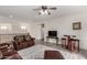 Spacious living room featuring wood laminate floors, a ceiling fan, neutral walls, and leather furniture at 9622 S 46Th Ln, Laveen, AZ 85339