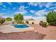 Backyard with a pool, rock waterfall feature, and mature landscaping at 9622 S 46Th Ln, Laveen, AZ 85339