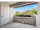Spacious outdoor balcony area with door and decorative wall at 9990 N Scottsdale Rd # 2029, Paradise Valley, AZ 85253
