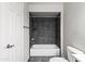 Bathroom with tiled shower, white toilet and dark floors at 9990 N Scottsdale Rd # 2029, Paradise Valley, AZ 85253