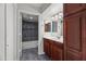 Bathroom with cherry vanity, updated lighting, and sleek, modern shower and tub at 9990 N Scottsdale Rd # 2029, Paradise Valley, AZ 85253