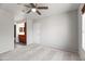 Bright bedroom with carpet and ceiling fan leading to the bathroom with cherry colored vanity at 9990 N Scottsdale Rd # 2029, Paradise Valley, AZ 85253