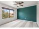 Bedroom features neutral carpet, a teal accent wall, and a view at 9990 N Scottsdale Rd # 2029, Paradise Valley, AZ 85253