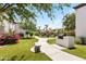 Manicured courtyard featuring lush lawn, mature trees, stone benches, and built in BBQ areas for outdoor enjoyment at 9990 N Scottsdale Rd # 2029, Paradise Valley, AZ 85253