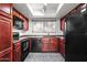 Galley kitchen with wood cabinetry, black appliances and skylight at 9990 N Scottsdale Rd # 2029, Paradise Valley, AZ 85253
