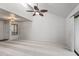 Open-concept living room with vaulted ceiling, fan, carpet, and a view to the sliding glass doors at 9990 N Scottsdale Rd # 2029, Paradise Valley, AZ 85253