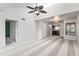Bright and airy living room with vaulted ceilings and a ceiling fan, carpet and an open view into the kitchen at 9990 N Scottsdale Rd # 2029, Paradise Valley, AZ 85253