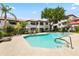 A community pool surrounded by lush landscaping and apartment buildings offers residents a relaxing oasis at 9990 N Scottsdale Rd # 2029, Paradise Valley, AZ 85253