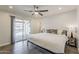 Sun-filled bedroom with ceiling fan, a sliding glass door, and a modern bed frame at 1003 E Marigold Ln, Tempe, AZ 85288