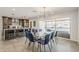 Bright dining room featuring modern light fixture and sliding doors leading to an outdoor living area at 1003 E Marigold Ln, Tempe, AZ 85288
