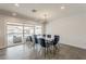 Bright dining room featuring modern light fixture and sliding doors leading to an outdoor living area at 1003 E Marigold Ln, Tempe, AZ 85288