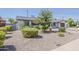 Landscaped front yard features updated desert landscaping and mature trees, providing curb appeal at 1003 E Marigold Ln, Tempe, AZ 85288