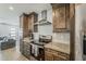 Charming kitchen featuring stainless steel appliances, wooden cabinets, and light countertops at 1003 E Marigold Ln, Tempe, AZ 85288