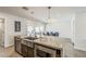 Kitchen boasts an island with a sink, stainless steel appliances, and an attached dining area, offering functionality at 1003 E Marigold Ln, Tempe, AZ 85288