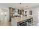 Modern kitchen features a large island with seating, stainless steel appliances, and stylish wood cabinetry at 1003 E Marigold Ln, Tempe, AZ 85288