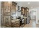 Charming kitchen featuring stainless steel appliances, wooden cabinets, and light countertops at 1003 E Marigold Ln, Tempe, AZ 85288