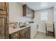 Cozy laundry room with wooden cabinets, a stainless steel sink, and modern washer and dryer at 1003 E Marigold Ln, Tempe, AZ 85288
