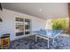 Covered patio boasts a game area with ping pong table and brick pavers at 1003 E Marigold Ln, Tempe, AZ 85288