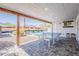 Covered patio has a ping pong table and barstools overlooking the pool area at 1003 E Marigold Ln, Tempe, AZ 85288