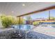 View of the ping pong table and covered patio with view to the colorful pool area at 1003 E Marigold Ln, Tempe, AZ 85288