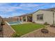 Beautiful backyard showcasing pool, covered patio, and well-maintained lawn for outdoor living at 11334 S 52Nd Ln, Laveen, AZ 85339