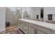 Modern bathroom featuring a double vanity, a glass-enclosed shower, and a walk-in closet at 11334 S 52Nd Ln, Laveen, AZ 85339
