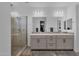 A beautifully designed bathroom with a glass-enclosed shower and a double vanity sink at 11334 S 52Nd Ln, Laveen, AZ 85339
