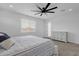 Bedroom with a light, airy feel, featuring a modern ceiling fan and large window, and ample natural light at 11334 S 52Nd Ln, Laveen, AZ 85339
