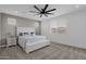Well-lit primary bedroom features a modern ceiling fan, plush carpet, and a large window at 11334 S 52Nd Ln, Laveen, AZ 85339