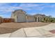 An exterior view of a stucco home with a brick driveway and multi-car garage at 11334 S 52Nd Ln, Laveen, AZ 85339