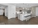 Bright kitchen featuring stainless steel appliances, a large island, stylish pendant lights and wood floors at 11334 S 52Nd Ln, Laveen, AZ 85339