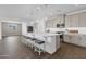 Bright kitchen featuring stainless steel appliances, a large island, stylish pendant lights and wood floors at 11334 S 52Nd Ln, Laveen, AZ 85339