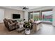 Living room offering access to an outdoor pool, showcasing a modern design with seamless indoor/outdoor transitions at 11334 S 52Nd Ln, Laveen, AZ 85339
