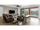 Inviting living room with tile floors, a ceiling fan, comfortable seating, and sliding glass doors to the backyard at 11334 S 52Nd Ln, Laveen, AZ 85339