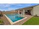 Sparkling pool with lounge chairs and umbrellas, perfect for enjoying sunny days in the backyard at 11334 S 52Nd Ln, Laveen, AZ 85339