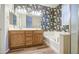 Inviting bathroom featuring double vanity, tub, shower, and decorative floral wallpaper at 1143 S Annie Ln, Gilbert, AZ 85296